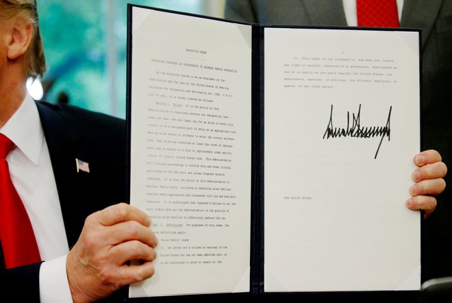 Donald Trump kaže podpisan dokument. FOTO: Leah Milllis/Reuters