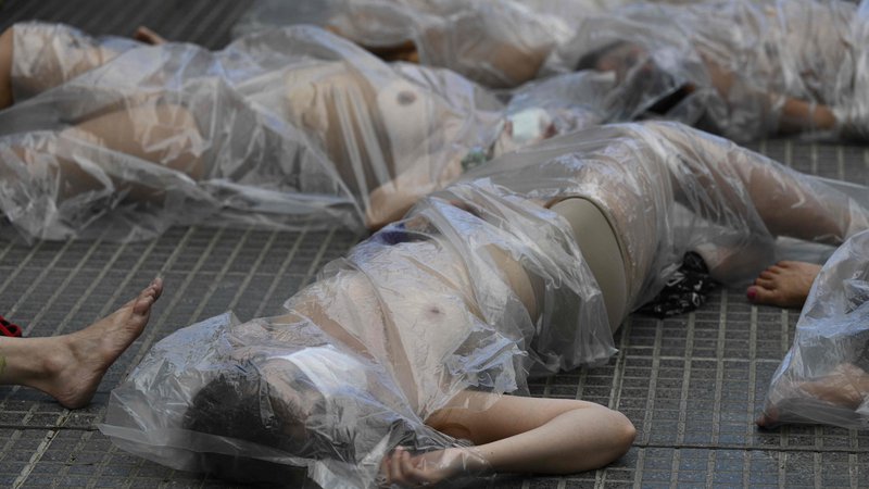 Fotografija: Pred palačo pravice v Buenos Airesu so protestirale gole ženske, zavite v plastične vrečke, s čemer zahtevajo pravico za žrtve femicida. FOTO: Juan Mabromata/Afp
 