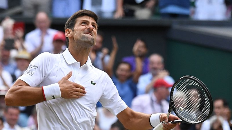 Fotografija: Novak Đoković je v Wimbledonu zmagal v letih 2011, 2014, 2015, 2018, 2019 in 2021. FOTO: Ben Stansall/AFP
