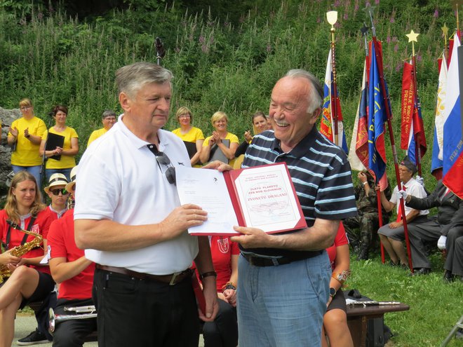 Zvone Dragan (na fotografiji desno) je iz rok predsednika slovenske borčevske organizacije Marijana Križmana prejel zlato plaketo za predano, aktivno in zelo uspešno utrjevanje zgodovinske resnice, vrednot in dosežkov NOB. FOTO: Bojan Rajšek/Delo
