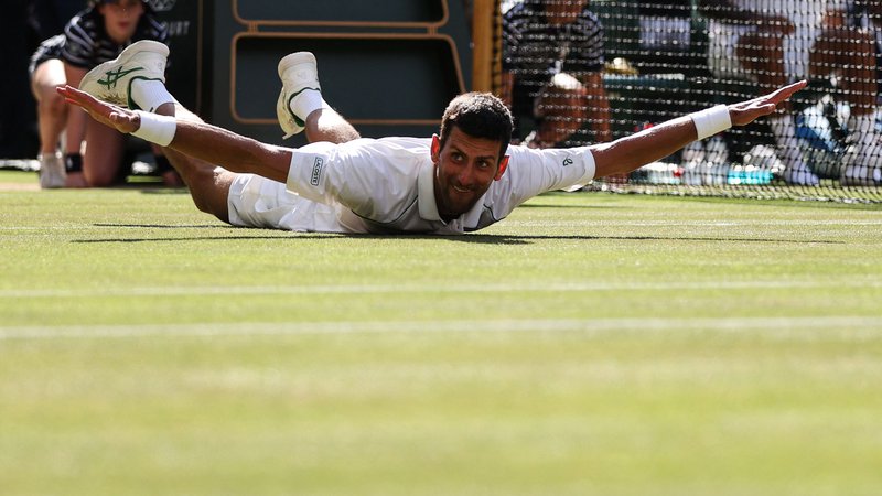 Fotografija: Novak Đoković se je v Wimbledonu veselilil 21. lovorike za veliki slam in ima le eno manj od Rafaela Nadala, ki bi ga lahko ujel na OP ZDA, če bo lahko igral na zadnjem največjem turnirju sezone. FOTO: Adrian Dennis/AFP
