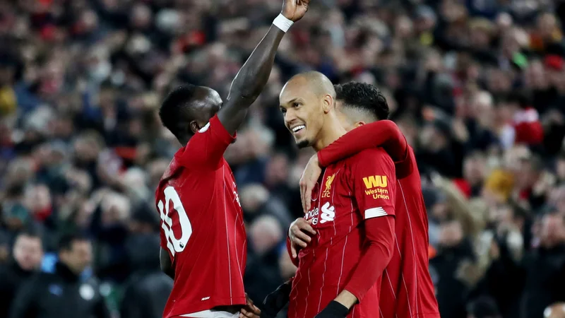 Fotografija: Strelca Sadio Mane in Fabinho skupaj z Robertom Firminom. FOTO: Reuters