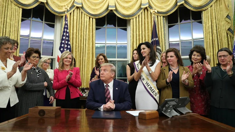 Fotografija: U.S. President Donald Trump is applauded after signing the Women's Suffrage Centennial Commemorative Coin Act during a bill signing ceremony in the Oval Office at the White House in Washington, U.S., November 25, 2019. REUTERS/Loren Elliott Foto Loren Elliott Reuters