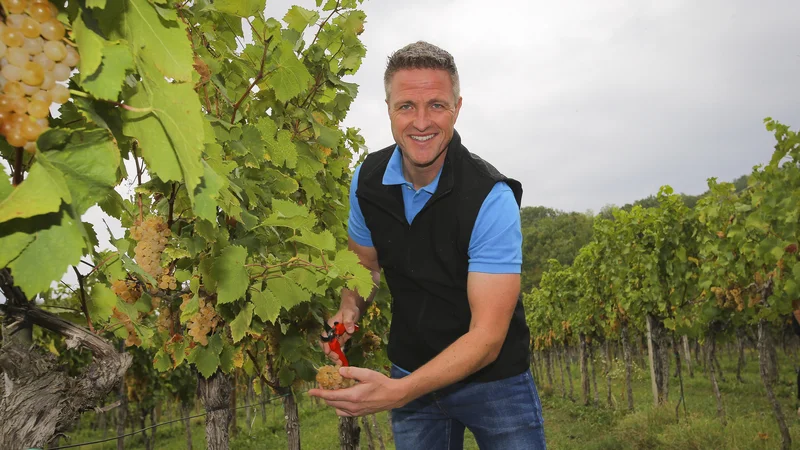 Fotografija: Nekdanji nemški dirkač Ralf Schumacher rebulo ponuja gostom v svoji restavraciji. FOTO: Jože Suhadolnik/Delo