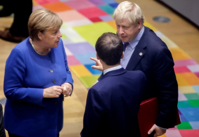 Britanski premier Boris Johnson, nemška kanclerka Angela Merkel in francoski predsednik Emmanuel Macron med oktobrskim vrhom EU v Bruslju. FOTO: Reuters