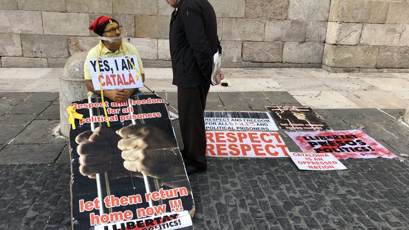 Fotografija: Protestnik se pred vladno palačo v Barceloni zavzema za izpustitev političnih zapornikov. Foto: Mimi Podkrižnik