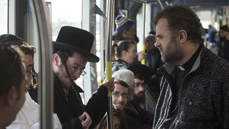 Fotografija: Tramvaj v Jeruzalemu: rdeča linija povezuje palestinski soseski Šuafat in Beit Hanun v Vzhodnem Jeruzalemu ter Herzlovo goro v Zahodnem Jeruzalemu, na njej pa se prepletejo življenje in usode številnih prebivalcev kulturno in religijsko mešanega mesta. Foto arhiv festivala Hiša strpnosti