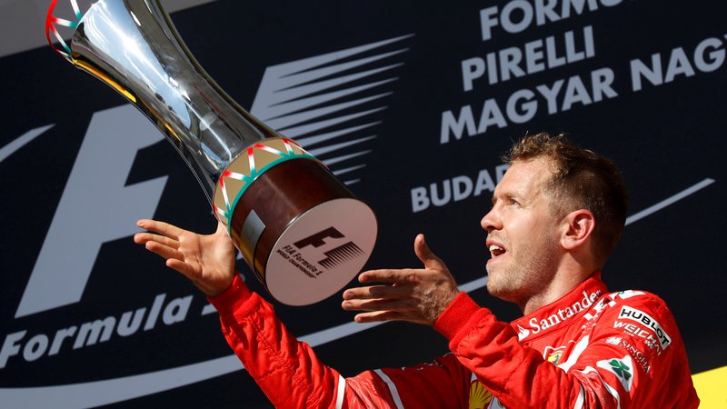 Fotografija: Sebastian Vettel si želi, da bi se v prihodnje pri Ferrariju še tako veselil, kot se je pred tremi leti po zmagi v Budimpešti. FOTO: Reuters