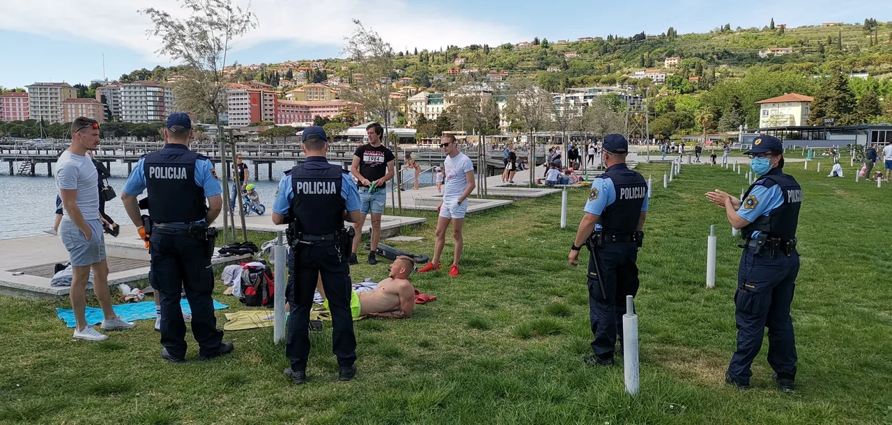 Fotografija: Policisti čistijo portoroško plažo. FOTO: Boris Šuligoj