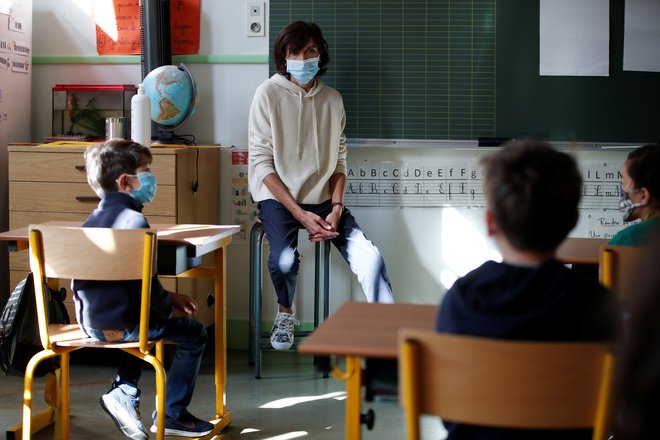 Tudi druge države so pri odpiranju šol upoštevale pravila razdalje med učenci in uporabo mask. Učencem prve triade v slovenskih osnovnih šolah mask ne bo treba nositi. FOTO: Reuters