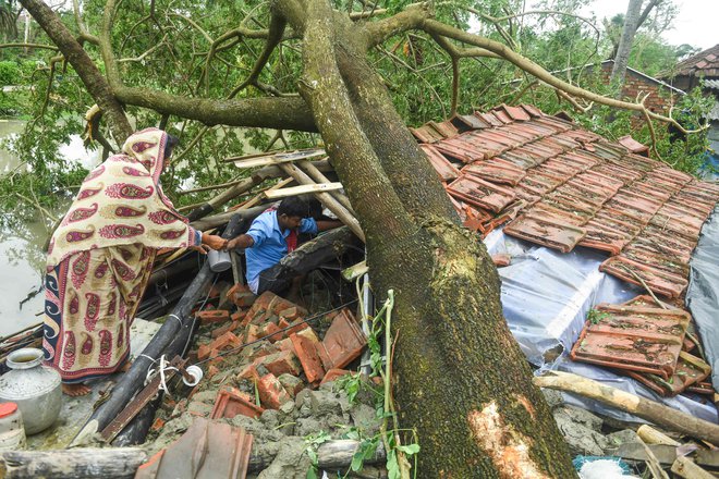 Vaščani v Zahodni Bengaliji rešujejo imovino iz uničenih hiš. FOTO: Dibyangshu Sarkar/AFP