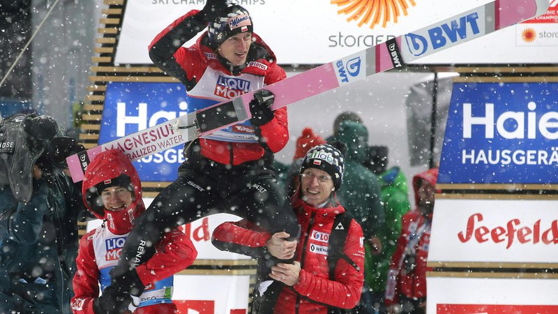 Fotografija: Poland's Dawid Kubacki (C) celebrates after winning the Men's ski jumping event at the FIS Nordic World Ski Championships on March 1, 2019 in Seefeld, Austria. (Photo by GEORG HOCHMUTH / APA / AFP) / Austria OUT
