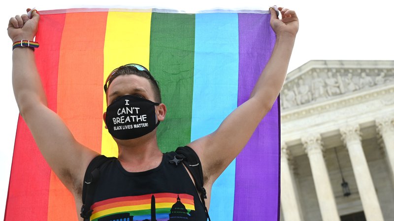 Fotografija: Protestnik za pravice LGBT+ delavcev pred ameriškim vrhovnim sodiščem v prestolnici Washington. Foto Jim Watson/Afp