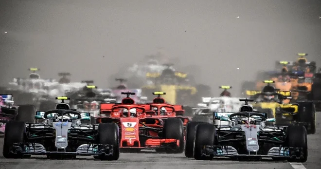 Valtteri Bottas (levo) je moral predse spustiti Lewisa Hamiltona, ki je bil pod pritiskom Sebastiana Vettla. FOTO: AFP