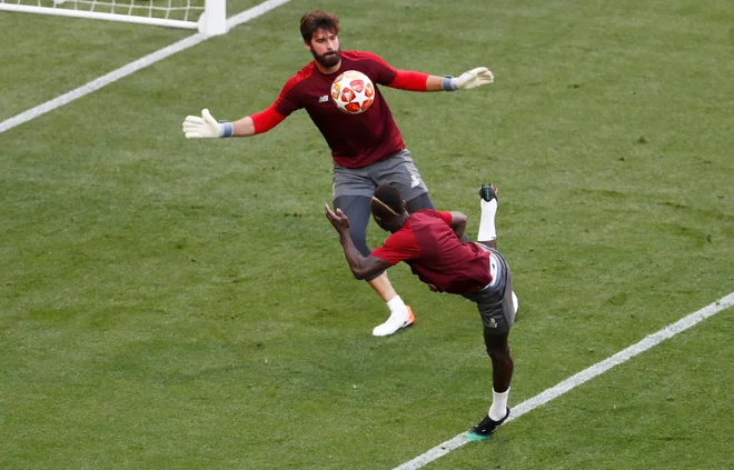 Vratar Alisson je uporabil Sadia Maneja za ogrevanje pred treningom. ​FOTO: Reuters