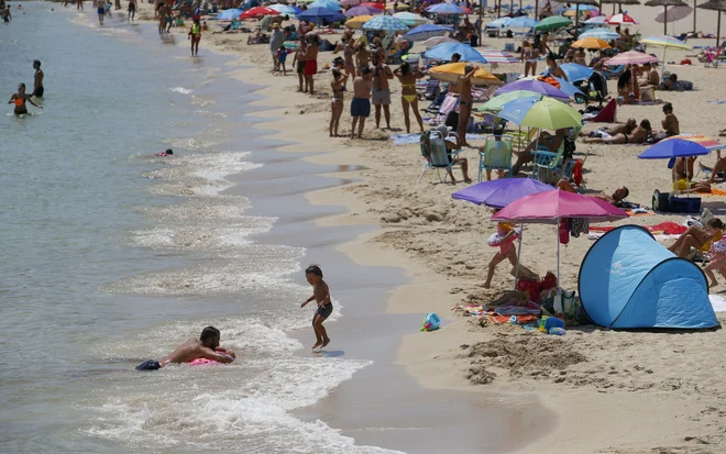 Nemški turisti se bodo morali ob vrnitvi v domovino z dopustovanja v tveganih območjih obvezno testirati na koronavirus. FOTO: Enrique Calvo/Reuters