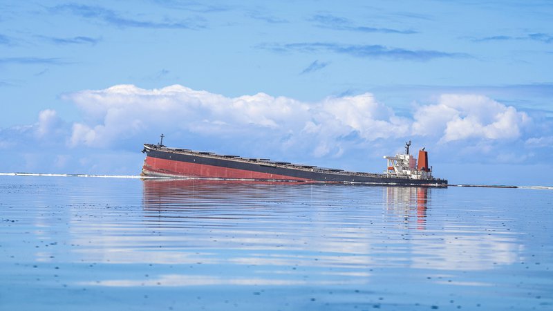 Fotografija: Plovilo MV Wakashio, ki pripada japonskemu podjetju, vendar je plulo pod panamsko zastavo, je nasedlo na skalo v morskem parku Blue Bay ob obali Mavricija. Francija je poslala letala in tehnične svetovalce na Mavricij, potem ko je premier pozval k nujni pomoči, da bi preprečili hujše razlitje nafte, ki onesnažuje znane grebene te otoške države. V ekološko zaščitenem morskem območju ob jugovzhodni obali je že izteklo vsaj 1000 ton nafte. FOTO: Daren MaureeAfp
