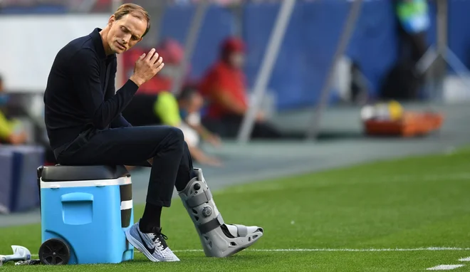 Thomas Tuchel, trener Parižanov, je zaradi poškodbe gležnja tekmo spremljal na klopi s posebno opornico. FOTO: David Ramos/AFP