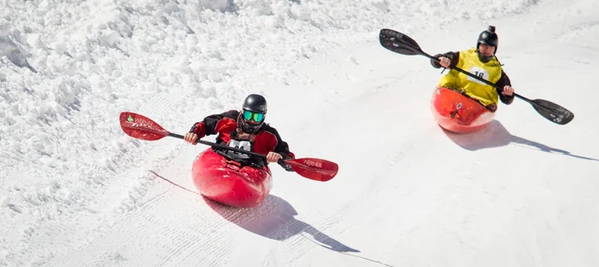 Competitors race down a flume built of snow in the annual Kayaks on the Snow event at Monarch Mountain.