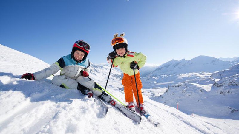 Fotografija: happy children in skiing outfit in snowy mountains