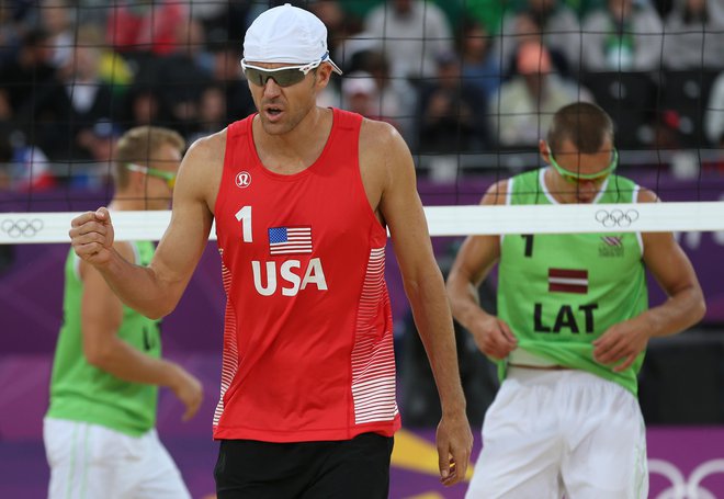 US Jake Gibb react during the quarterfinal men's beach volleyball match against Latvia at the 2012 Summer Olympics, Monday, Aug. 6, 2012, in London. (AP Photo/Petr David Josek)