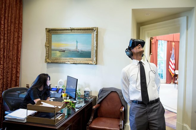 President Barack Obama watches a virtual reality film captured during his trip to Yosemite National Park earlier this year, in the Outer Oval Office, Aug. 24, 2016. Personal aide Ferial Govashiri sits at her desk at left. (Official White House Photo by Pe