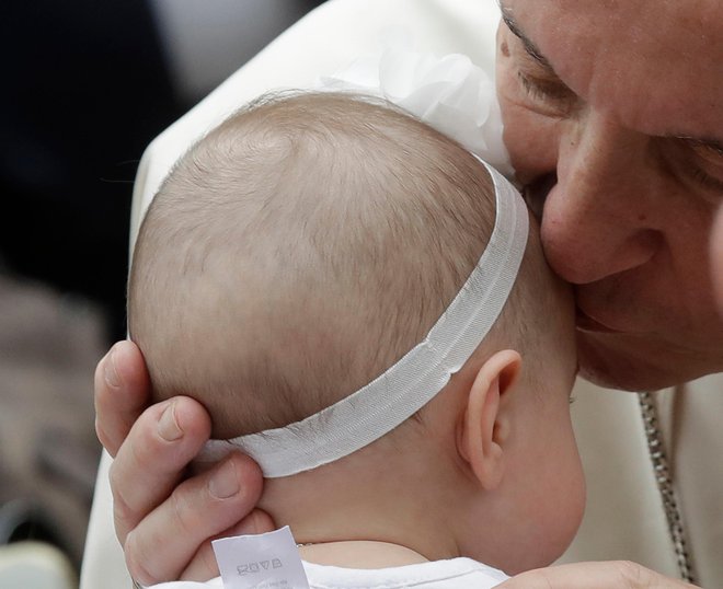 Pope Francis kisses a baby during his visit to the parish church of San Paolo della Croce, in Corviale neighborhood, Rome, Sunday, April 15, 2018. (AP Photo/Alessandra Tarantino)