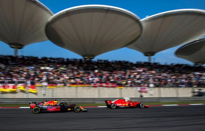 Daniel Ricciardo je v desetih krogih na svežih gumah prišel s šestega na prvo mesto, na ravnini je švignil mimo Sebastiana Vettla. FOTO: AFP