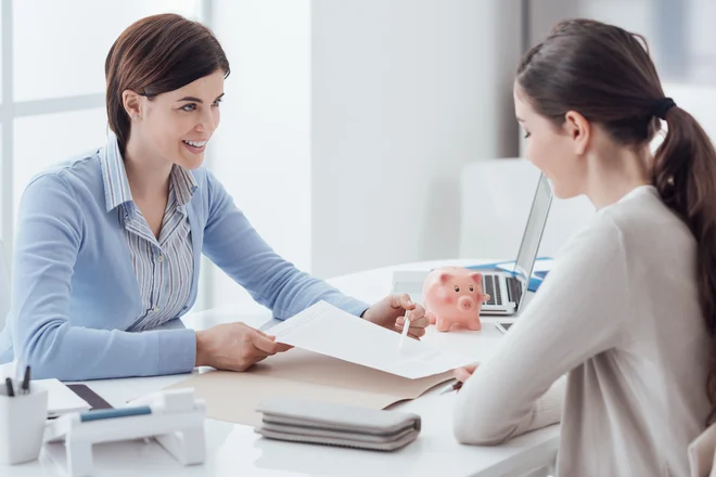 Business consultant and customer meeting in the office, the businesswoman is holding a contract and pointing