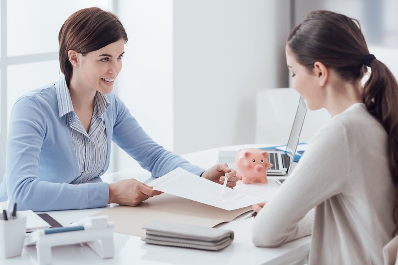 Fotografija: Business consultant and customer meeting in the office, the businesswoman is holding a contract and pointing