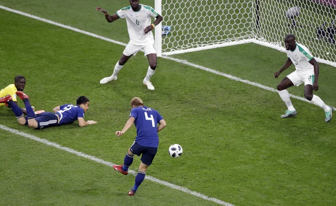 Keisuke Honda je vskočil z rezervne klopi in Japonski zagotovil točko. Foto Mark Baker/AP