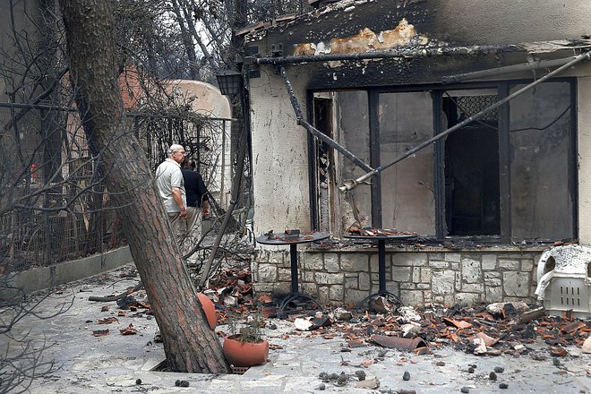 Tamkajšnji prebivalci z obupom pregledujejo, kaj je ostalo od njihovih domov. FOTO: Reuters