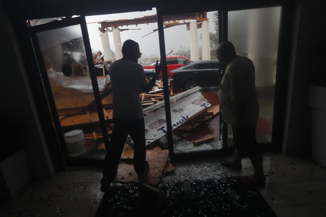 Uslužbenca hotela v Panama Cityju ocenjujeta škodo. FOTO: AP<br />
 