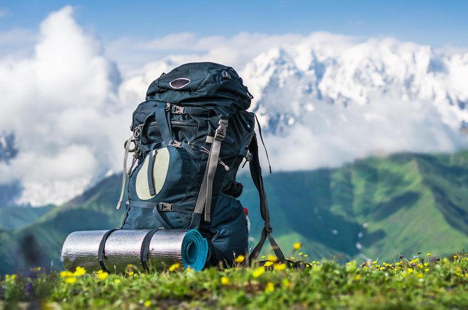 Tourist backpack and sleeping pad on a background of mountains, Georgia (Svaneti)