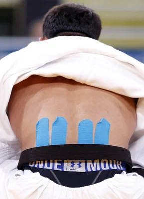 Greece's Ilias Iliadis, sporting Kinesio tape on his back, fights with Lithuania's Karolis Bauza during their men's -90kg elimination round of 16 judo match at the London 2012 Olympic Games August 1, 2012.                 REUTERS/Kim Kyung-Hoon (BRITAIN  - Tags: SPORT OLYMPICS SPORT JUDO)  