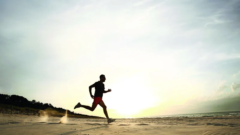 Fotografija: Man running on beach at sunset