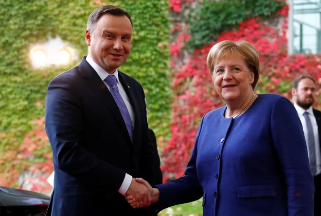 Nemška kanclerka Angela Merkel pozdravlja poljskega predsednika Andrzeja Dudo v Berlinu. Foto: Fabrizio Bensch/Reuters
