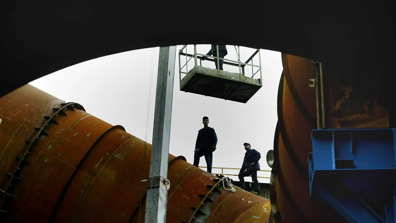 Fotografija: Silhuete delavcev, ki popravljajo plinovod podjetja BH-Gas v Zenici. FOTO: Danilo Krstanovic/Reuters
