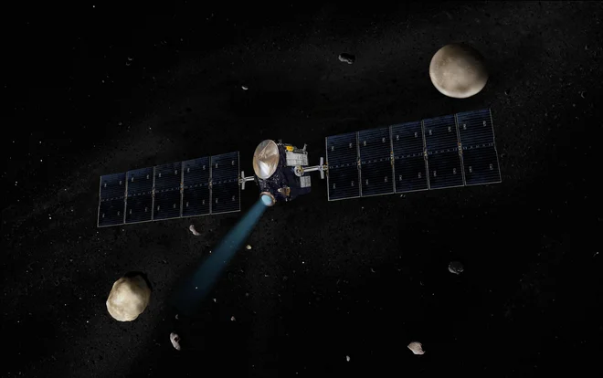 Umetniška upodobitev sonde Dawn med Vesto in Cerero. FOTO: NASA/JPL