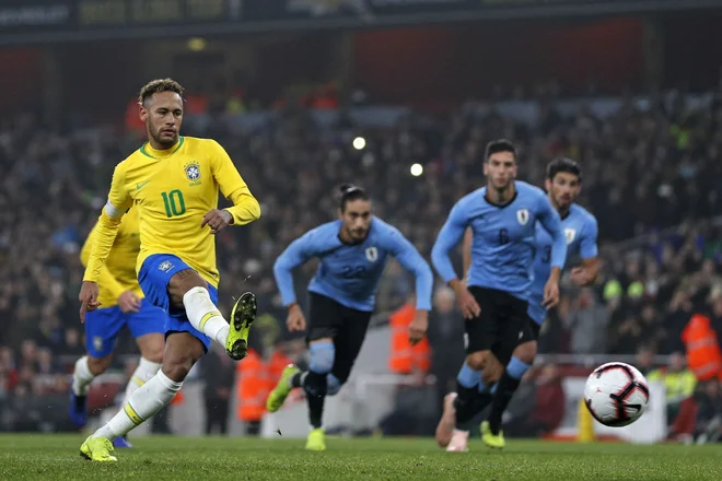 Neymar je urugvajskega vratarja poslal v napačno smer. FOTO: Adrian Dennis/AFP