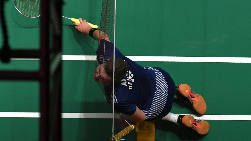 Fotografija: Na dvoboju badminton turnirja v Kuala Lumpurju je Danec Viktor Axelsen, ki se je pomeril proti Malezijcu Lee Zii Jia, pristal z glavo v mreži. Foto Mohd Rasfan Afp