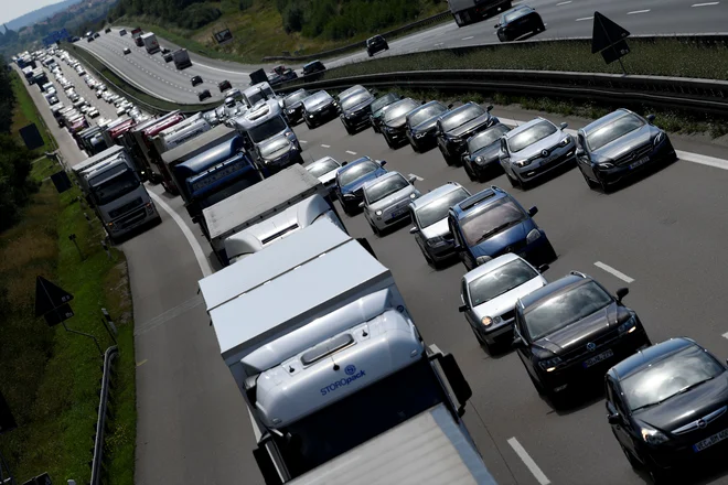 Cars and trucks drive along a motorway near Roth, Germany, August 9, 2018. REUTERS/Andreas Gebert - RC17C6A4B820