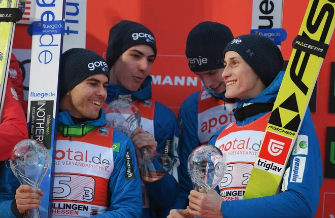 Slovenski skakalci Jernej Damian, Timi Zajc, Anže Semenič in Peter Prevc so se v petek veselili ekipnega 3. mesta, danes pa bodo izvedeli, kdo potuje na SP v Avstriji. FOTO: Arne Dedert/AFP