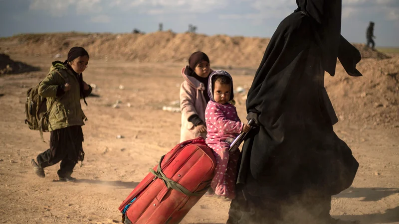 Fotografija: Ženske in otroci v begu pred spopadi za zadnje metre Islamske države. FOTO: AFP