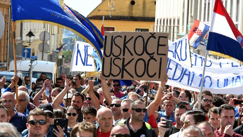 Fotografija: »Uskok, vskoči« je poziv na transparentu hrvaškim preiskovalcem korupcije, naj se lotijo neprevilnosti pri sanaciji ladjedelnice Uljanik, materi vseh državnih potratnosti. FOTO: Stringer/Afp