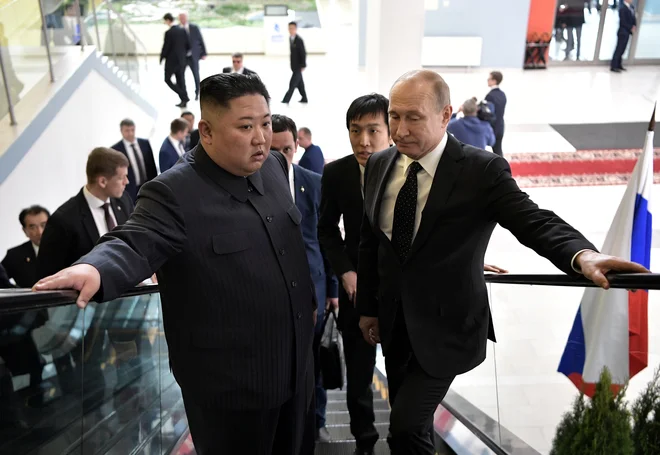 Kim je vedel, da bo vsak njegov stisk Putinove roke pod budnim očesom Donalda Trumpa. FOTO: Reuters
