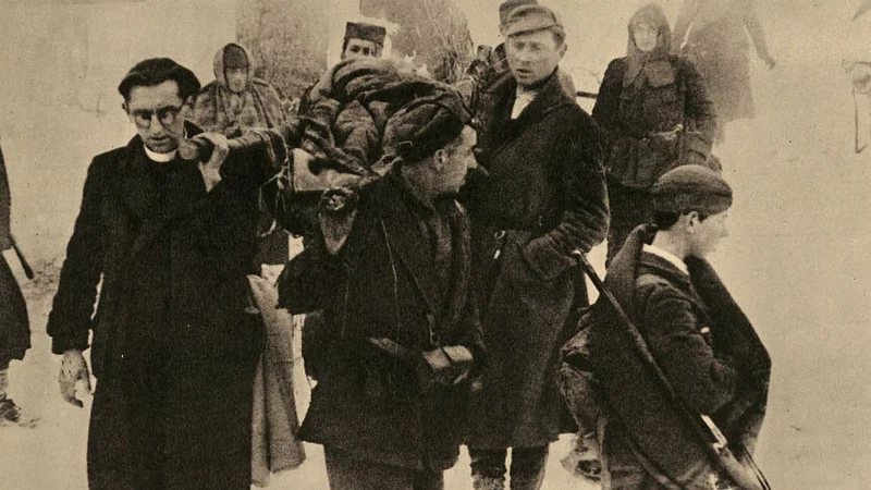 Njegovo sliko, kako nosi ranjence, so v času vojne objavili nacistični okupatorji in jo pospremili z zasmehljivim zapisom o &raquo;banditskem duhovniku&laquo;. Foto Wikimedia Commons