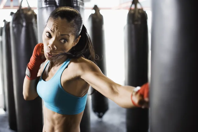 Woman hitting punching bag