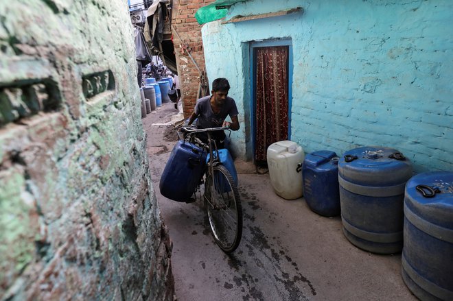 Moški s tankom za vodo. FOTO: Anushree Fadnavis/Reuters