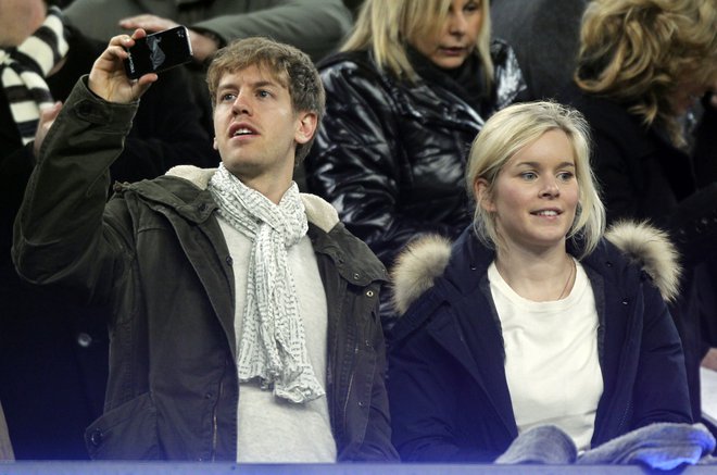 Sebastian Vettel se je po dirki v Montrealu skrival poročil s svojo življenjsko sopotnico Hanno Prater. FOTO: Reuters